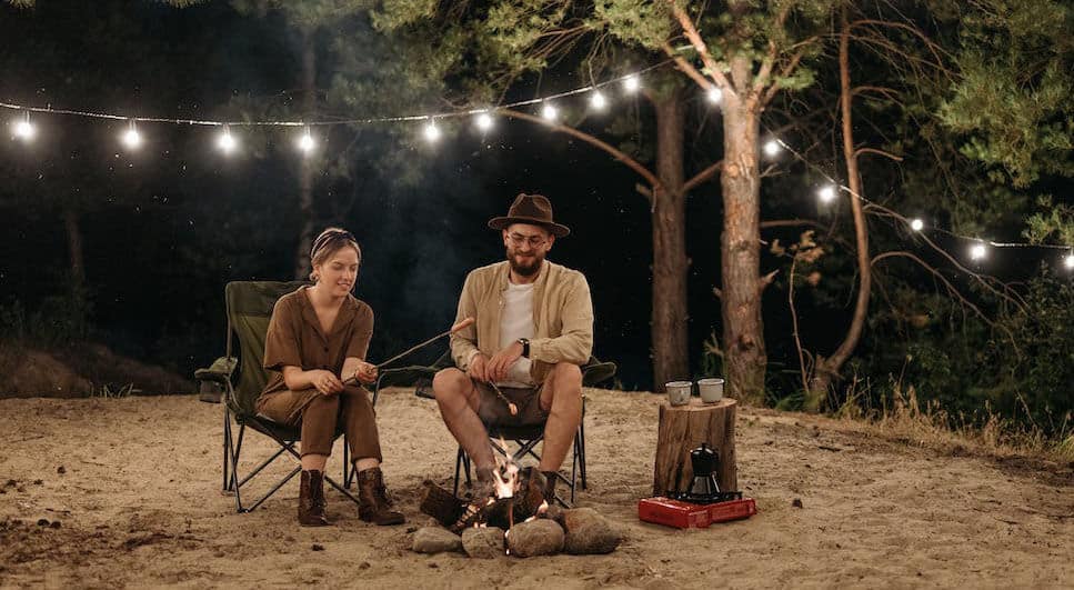 couple playing around campfire