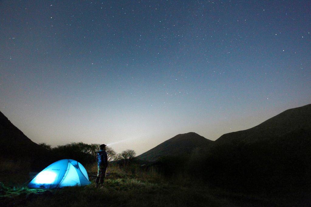 man with a tent at night